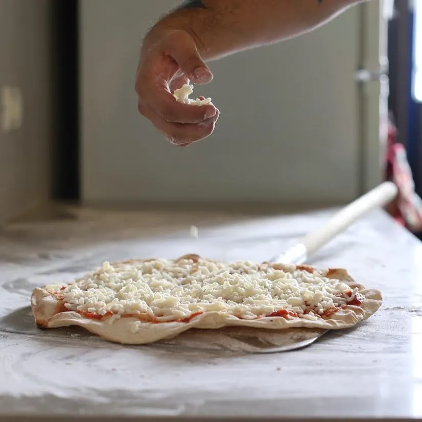 Paneer tikka pizza with Indian-spiced cottage cheese at Strathcona Pizza Edmonton